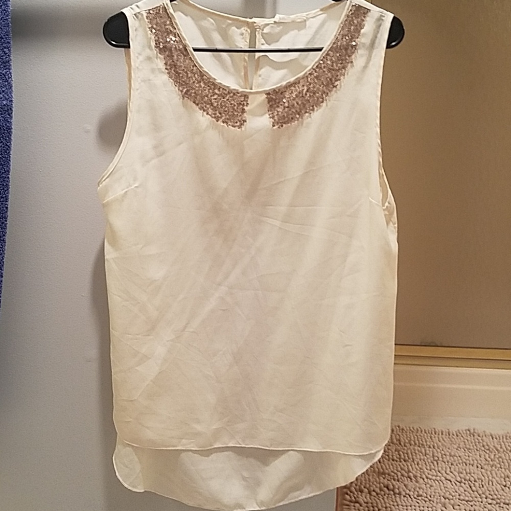 Cream tank top with embellished neck.